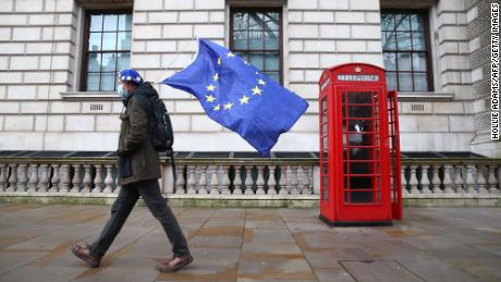 A man wearing a hat bearing the European Union flag and carrying the European Union flag is seen in Whitehall, central London, on December 11, 2020.