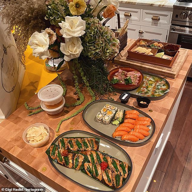 Yum: The second photo in the gallery showed a delicious spread of sushi and other appetizers, along with a stunning flower bouquet and white Prada shopping bag